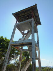 an abandoned monitoring tower that has been vandalized photographed from below
