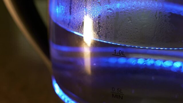 one liter of water in a kettle warming up with blue light 