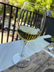 Glass of white wine on a table in a restaurant, close-up