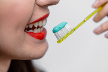 A Woman Is Brushing Her Teeth With a Toothbrush