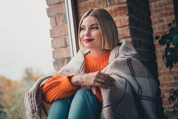 Portrait of minded gorgeous lady sit window sill covered blanket look interested away contemplate...