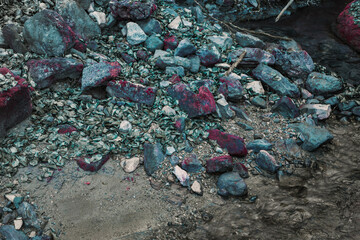 blue stones next to a river. fantasy landscape of blue stone covered with pink moss. a stream in a fantasy environment