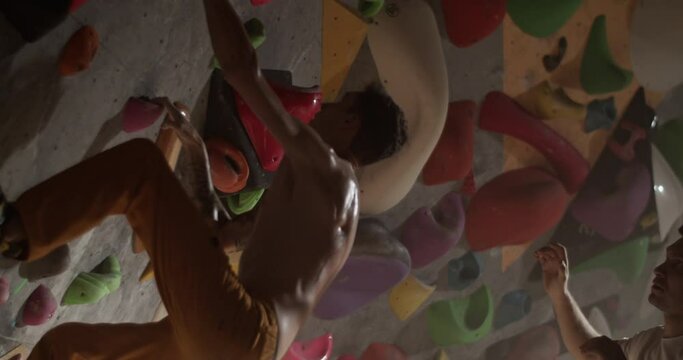 Man climber standing in gym with coach
