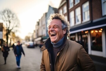 Portrait of a middle-aged man laughing in the city.