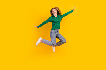 Fototapeta na wymiar Full body length photo of carefree young girl flying wings arms wear trendy outfit clothes at party isolated on yellow color background