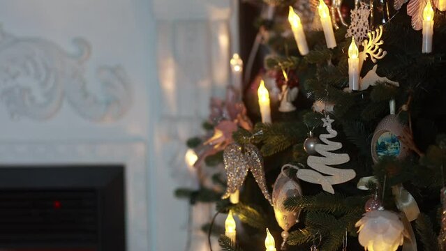 Festive New Year photo with Christmas tree, fireplace. Table with tangerines and branches of spruce, sweets and grapes for the holiday.