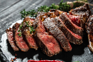 Grilled sliced beef steak with red wine. banner, menu, recipe copy space, top view - obrazy, fototapety, plakaty