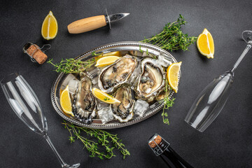 Oyster dinner with champagne in restaurant. Restaurant menu, dieting, cookbook recipe top view