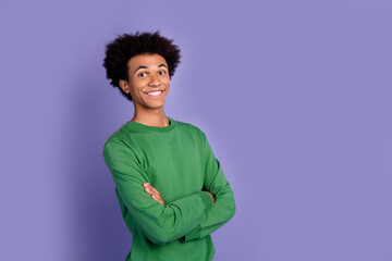 Fototapeta premium Photo of cheerful good mood guy wear green pullover arms folded empty space isolated purple color background
