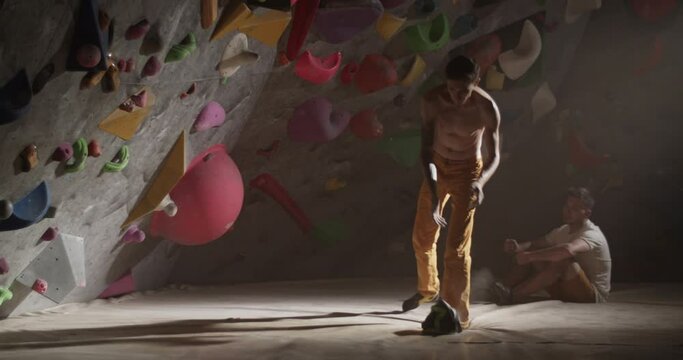 Man climber climbing gym wall with holds