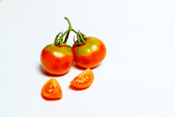 Red tomatoes on a white background, cherry tomatoes