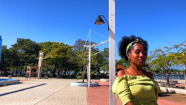 Dramatic slow motion shot of Afro Cuban woman dancing in a park