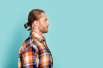Side profile photo of serious confident brutal man long hair dressed checkered shirt look empty space isolated on teal color background