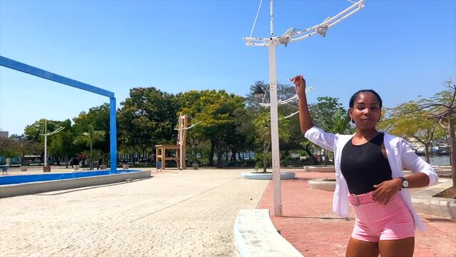 Latina woman dances in Parque de la Alameda Santiago de Cuba
