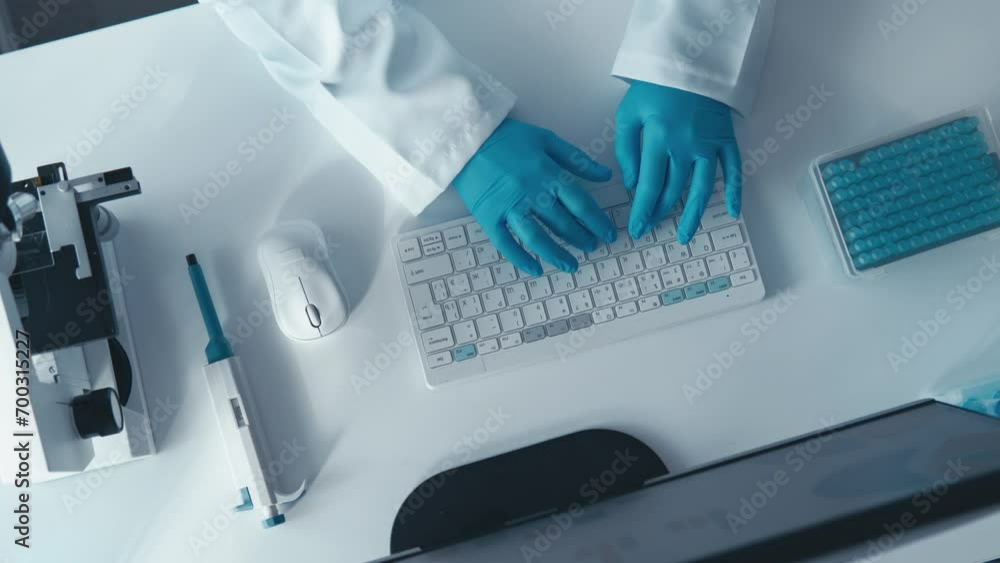 Poster Entering information about the results of analysis and chemical parameters into the database. Maintaining electronic reports and statistics. At the computer at the white table top view.