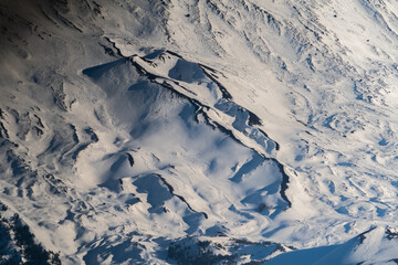Bronte town under the snowy and majestic volcano Etna and a cloudy blue sky