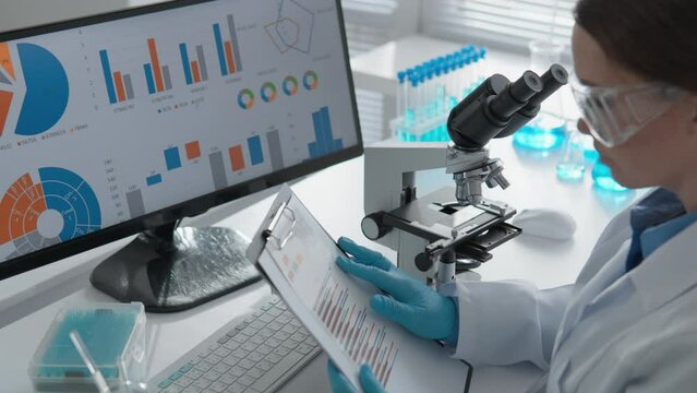 Laboratory work at the computer research center is devoted to the study of chemical processes and the development of new medical technologies. In a hazmat suit, the scientist carefully examines a