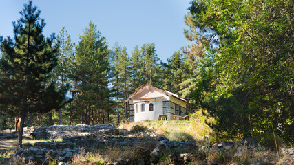 Saint Nicholas Church behind ancient Thracian ruins hidden in Pirin Mountains near Dobrinishte, Bulgaria.