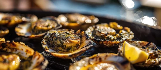 Aluminium Prints Canary Islands Grilled limpets with lemon, a traditional dish in Madeira and a typical snack in the Canary Islands.