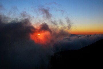 Fototapeta na wymiar Mauna Kea sunset over the clouds, Big Island, Hawaii