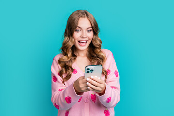 Portrait of funny woman wearing pink cardigan strawberry print using smartphone shock download tiktok isolated on blue color background