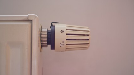 Caucasian Male Turning Up and Down Room Heater Using Thermostat Temperature Regulator Knob