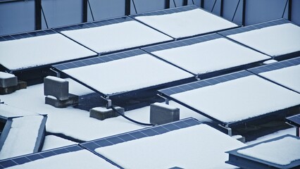 Roof Mounted Photovoltaic Solar Panels Array Covered in Thick Layer of Snow Blocking Sunlight Rays...