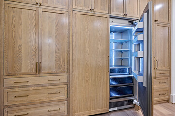 Open Refrigerator Cabinet in Modern Kitchen - 700330417