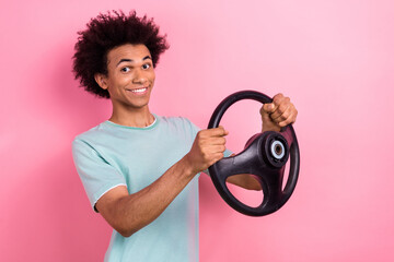 Photo of positive good mood man dressed blue t-shirt riding automobile empty space isolated pink...