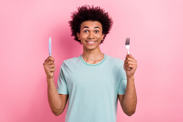 Photo portrait of nice young guy hold fork knife ready eating tasty food wear trendy blue outfit...
