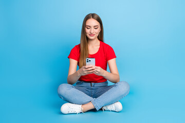 Photo of adorable cute lady wearing stylish red clothes writing comment sending sms apple iphone isolated on blue color background