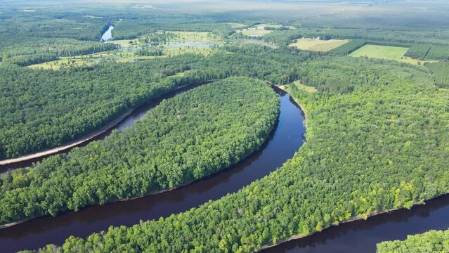 Flying over a very winding river and forest in Northern Minnesota near the border of Canada