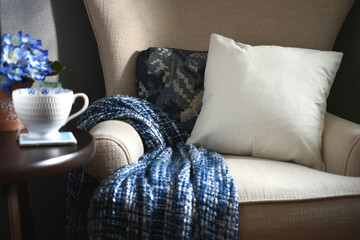 Plain canvas throw pillow suitable for mock up mockup on a chair with blue throw blanket - your...