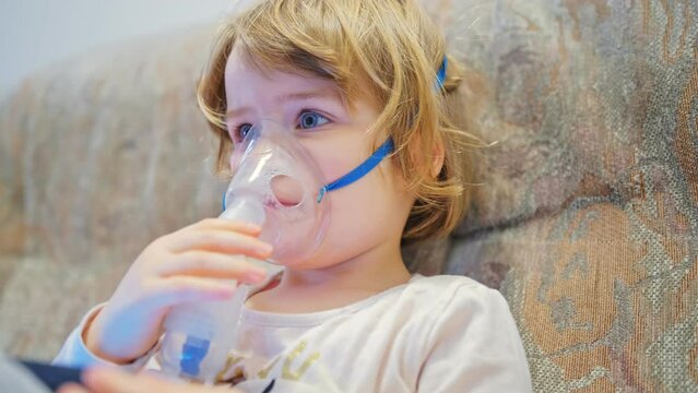 Young Adorable Caucasian Preschooler Girl Wearing Nebulizer Mask Inhaling Cough Medicine Steroid Drug for Respiratory Desease Treatment