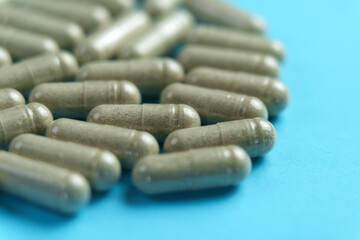 White medication pills on a blue background. Healthcare medicament
