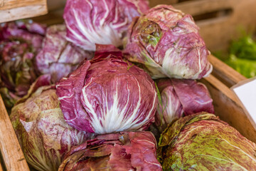 Close up of radicchio on display at an outdoor farmers' market.
