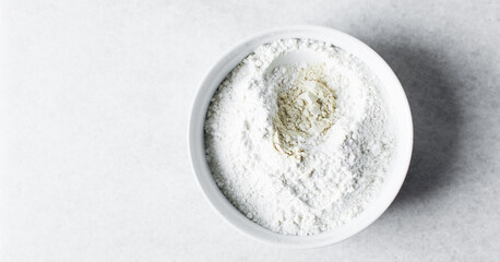 All purpose flour in a ceramic bowl, baking flour in a bowl banner