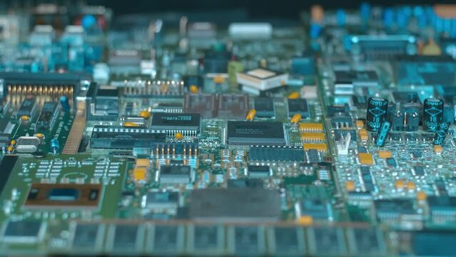 Electronic boards with many different microcircuits and other radio components show the complexity of the products of the modern electronics industry. Closeup. Macro. Shot in motion