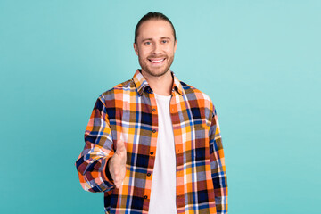 Photo of friendlu cheerful nice man with stubble dressed checkered shirt stretching arm to you...