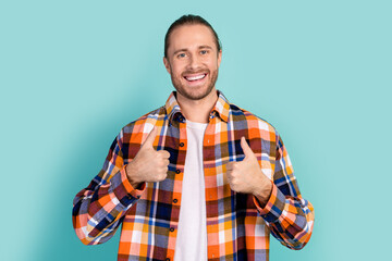 Photo of satisfied cheerful man with beard dressed flannel checkered shirt showing thumbs up good...