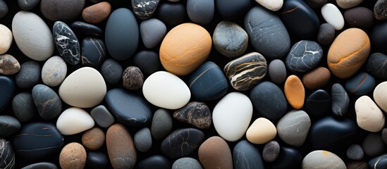 background of white and black stones lying on the beach sand