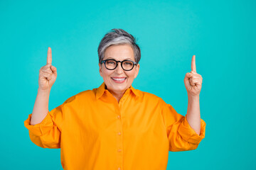 Photo of mature age business woman direct fingers up promoting financial service helps users count...