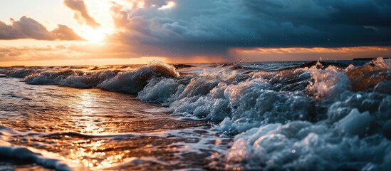 Stormy weather and captivating sunset over Baltic Sea in Latvia. Close-up shot of waves. Majestic spring scenery with indications of cyclone and climate change.