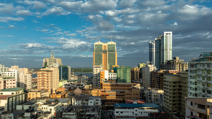Cityscape of Dar es Salaam at sunset featuring residential and office buildings.