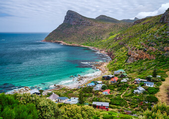 Secluded beach village of Smitswinkel Bay with turquoise water surrounded mountain, cape peninsula,...
