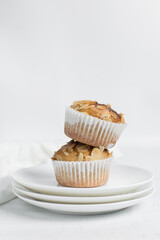 vanilla almond muffins on a white plate, homemade bakery style almond muffins on a white background