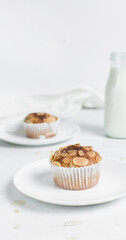 vanilla almond muffins on a white plate, homemade bakery style almond muffins on a white background