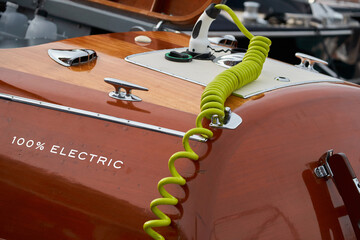 the wooden side of the modern electric elegance motor boat in port of Hercules in Monaco, green...