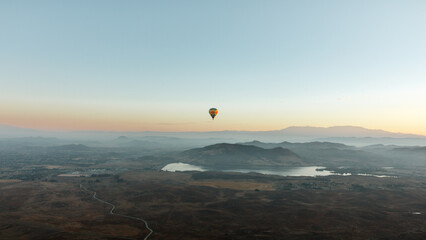 The Lone Balloon: Floating silently at sunrise above the Temecula Valley Wine Country with Skinner Reservoir in the background. © Brandon Labine