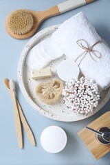 Bath accessories. Flat lay composition with personal care products on light blue background